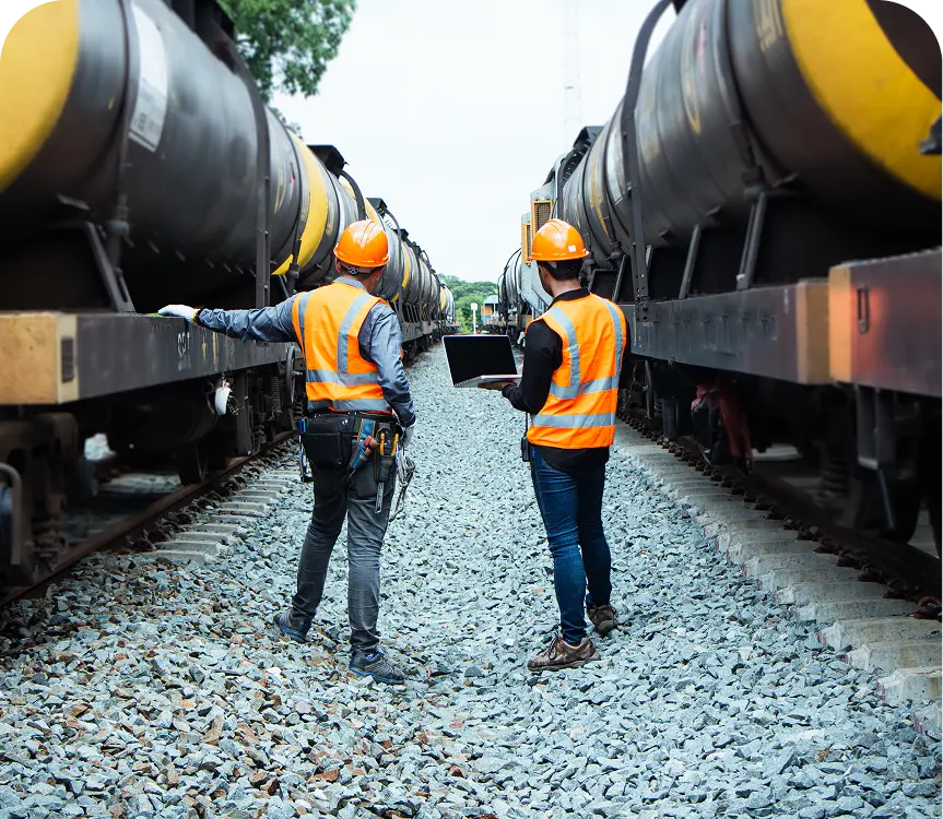 Rail workers inspecting freight trains